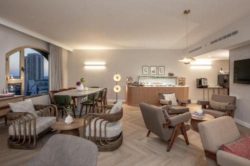 a living room with chairs and a table at Leonardo Hotel Negev in Beer Sheva