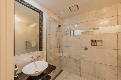 a bathroom with a sink and a shower at The Andromeda Hideaway - 6BR Hot tub BBQ in Lake Tekapo