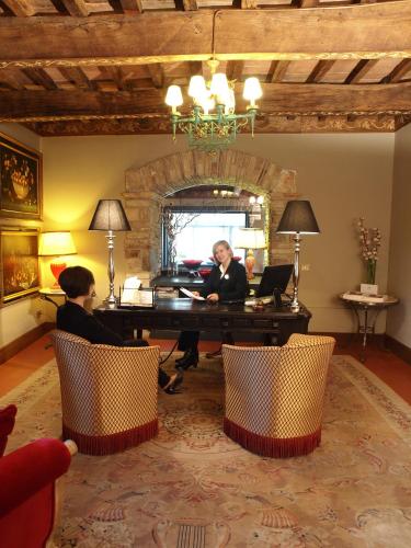 a woman sitting at a piano in a living room at Relais Todini - Residenza d'epoca - Luxury Historic house in Todi