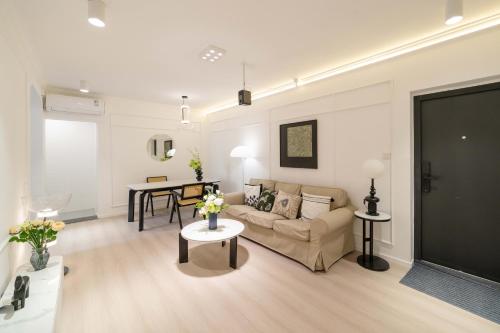 a living room with a couch and a table at Shanghai Yi Du B&B - Family Suite 500m to Nanjing West Rd Near People's Square -Credit Cards Accepted in Shanghai