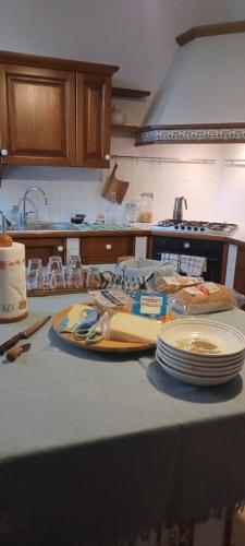 a kitchen counter with plates and dishes on a table at Villa Gildanna2 in Orio Litta