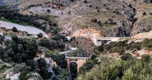 a bridge on the side of a mountain with a road at Maistros Villa in Rodakino