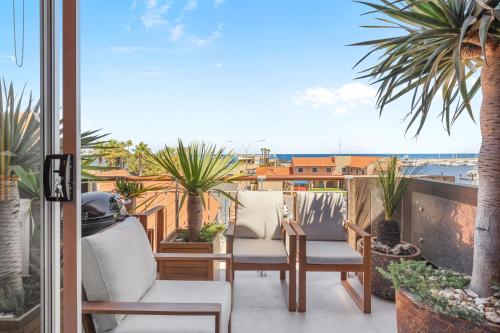 a balcony with two chairs and a view of the ocean at Nautica Residences Hillarys in Perth