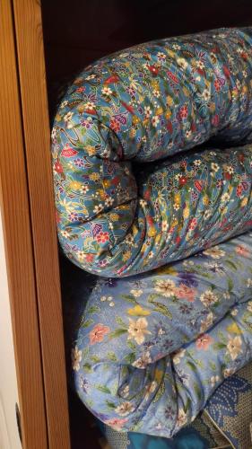 three blankets are stacked on top of each other at Nonna Milli in Matsumoto