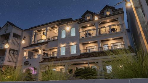 a large white building with lights on it at night at Taean Fringe OceanView Pension in Taean