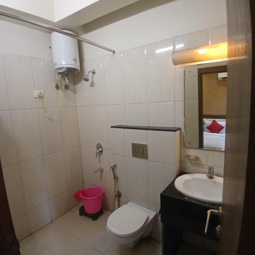 a bathroom with a toilet and a sink at Hotel Square 36 in Kota