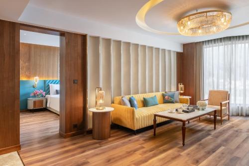 a living room with a couch and a table at Taj Mussoorie Foothills, Dehradun in Dehradun
