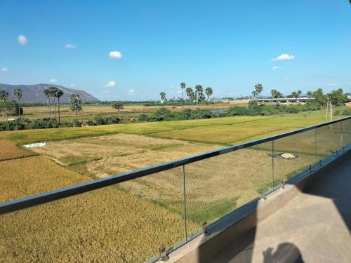 a balcony with a view of a field of grass at Suhana Aangan Homestay in Tirupati