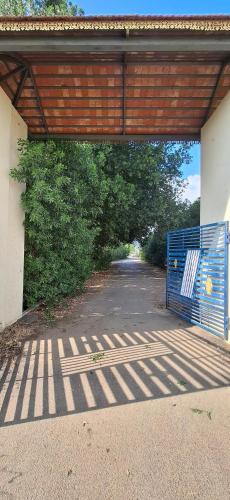 a garage with a blue gate on a road at Suhana Aangan Homestay in Tirupati