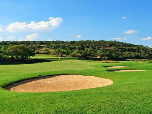 an overhead view of a green golf course with a bunker at Elements Private Golf Reserve in Bela-Bela