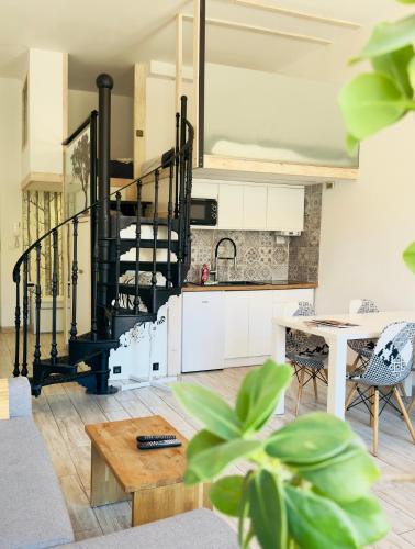 a kitchen and living room with a spiral staircase at Wroclaw Inn Apartments in Wrocław