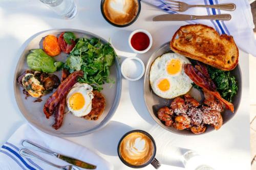two plates of breakfast food on a white table at In Vino Veritas in Arcola