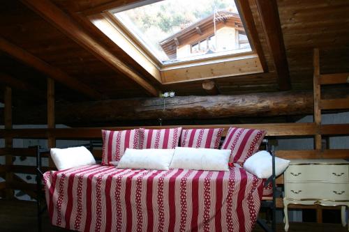 a bed in a room with a skylight at Casa del Vasaio in Tenno