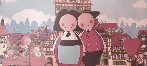 a cartoon of two people standing in a city at Gîte et chambres d'hôtes Les Framboises in Katzenthal