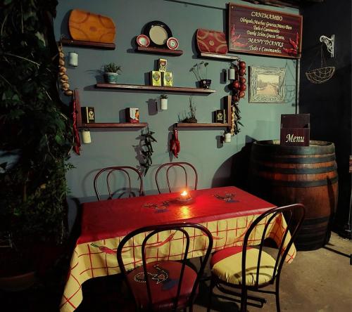 a red table with chairs and a candle on it at Canimambo at The Old Post Office Inn in Graskop