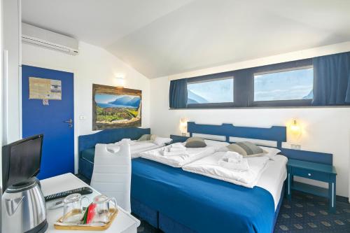 Letto o letti in una camera di Bike & Wind Hotel Villa Maria
