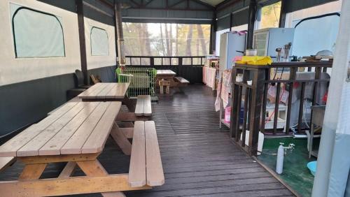 a room with benches and tables in a trailer at Namwon Along the Waterways of Jiri Mountain in Namwon