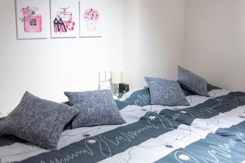 a bed with blue and white sheets and pillows at Y's INN Nakano 016T in Tokyo