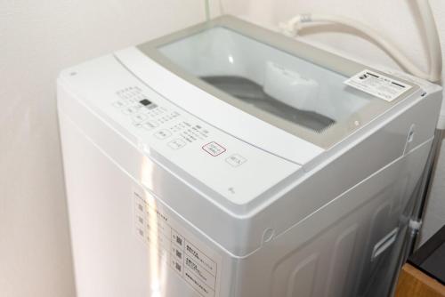 a white washer and dryer in a room at Y's INN Nakano 016T in Tokyo