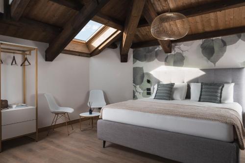 a bedroom with a large bed and a skylight at Palazzo dei Guardiani in Venice