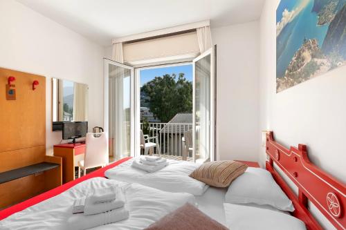Letto o letti in una camera di Bike & Wind Hotel Villa Maria
