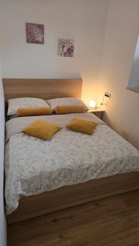 a bed with two pillows on it in a bedroom at Vila Rajska ptica in Bled