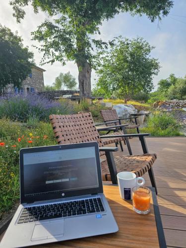 a laptop sitting on a table with a cup of coffee at Boutique Resort OSMA - Adults Only in Malinska