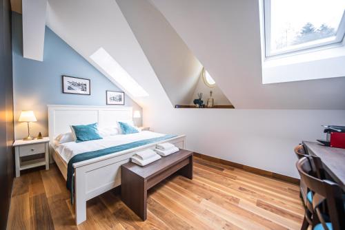 a bedroom with a bed and a table at Vila Slavia in Luhačovice