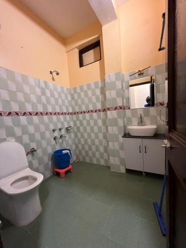 a bathroom with a toilet and a sink at Vacation home in Dharmsala