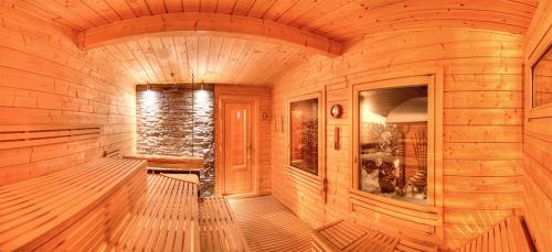 a large wooden room with a wooden floor and a window at Hotel Alpenhof in Bad Wörishofen