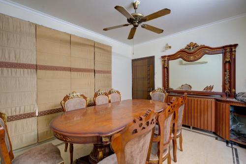 a dining room with a table and chairs and a mirror at Amrit Hotel - Hotel & Banquet,Sector 32 in Gurgaon