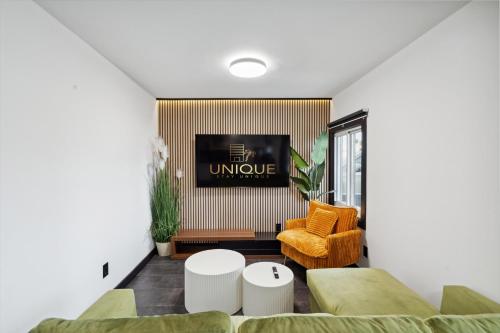 a living room with a couch and a tv at Luxury Meets Wellness Spa Rtrt in Phoenix