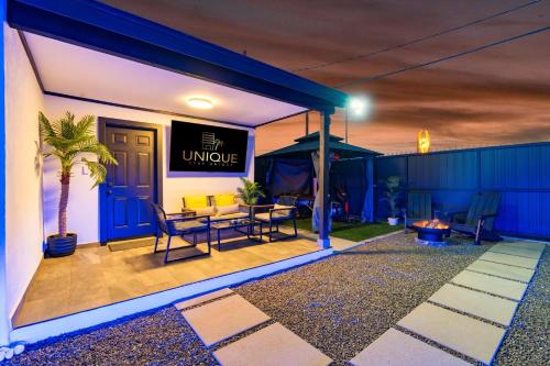 a patio at night with a table and chairs at Luxury Meets Wellness Spa Rtrt in Phoenix