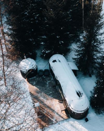 two snow covered cars are parked in the snow at Pedaspä Igloo House and Sauna in Pedaspea