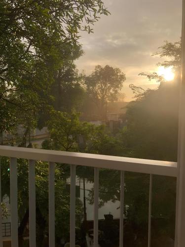 a view of a balcony with the sun in the sky at NhaBoong-Homestay Riverside Ninh Binh in Ninh Binh