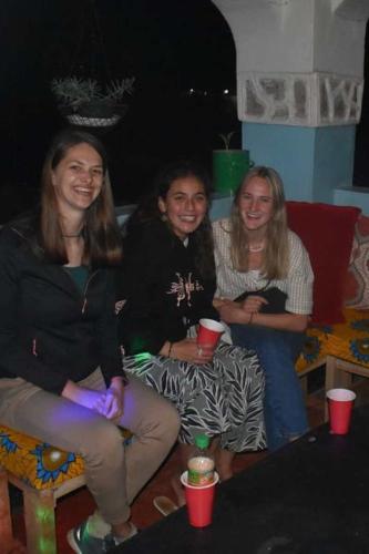 a group of three women sitting on a couch at EMMY'S HIDE AWAY in Iringa