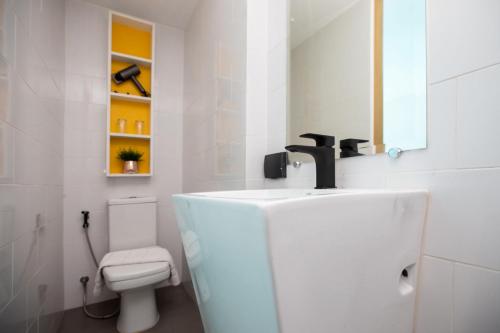 a bathroom with a sink and a toilet at Poolside Duplex In Nai harn UTL A102 in Rawai Beach