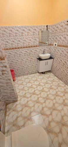 a bathroom with a toilet and a sink at Vacation home in Dharmsala