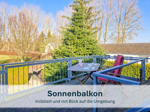 a blue railing with a table on a balcony at Peenemünde, Fewo OG in Peenemünde