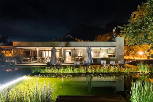 a house with a swimming pool at night at Angala in Simondium