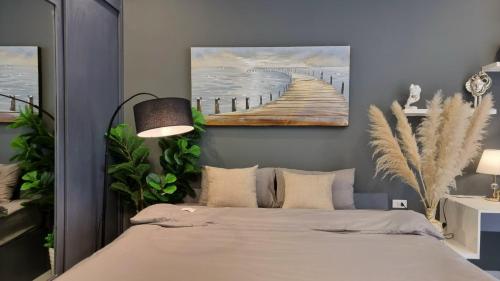 a bedroom with a bed with a painting on the wall at LaHomestay Hồng Hà in Hanoi
