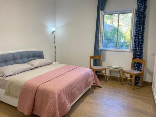 a bedroom with a bed and a window at Bellavista in Selva di Fasano