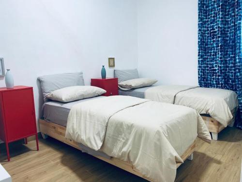 a room with two beds with white sheets at Bellavista in Selva di Fasano