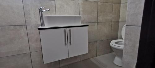 a bathroom with a sink and a toilet at Entire Self-Catering Apartment in Silverfields in Krugersdorp