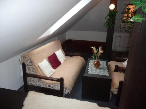 a living room with a couch and a table at Penzion Zavodsky in Český Krumlov