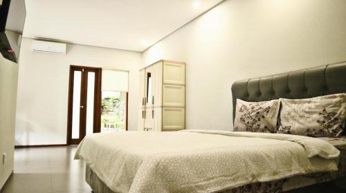 a bedroom with a large bed in a room at Proven Living in Bandung