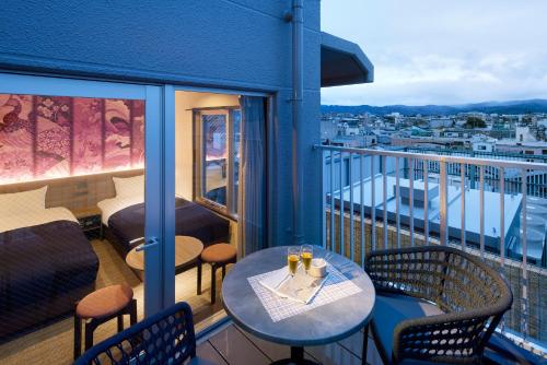 a balcony with a table and chairs with a view at Minn Gion Kamogawa in Kyoto