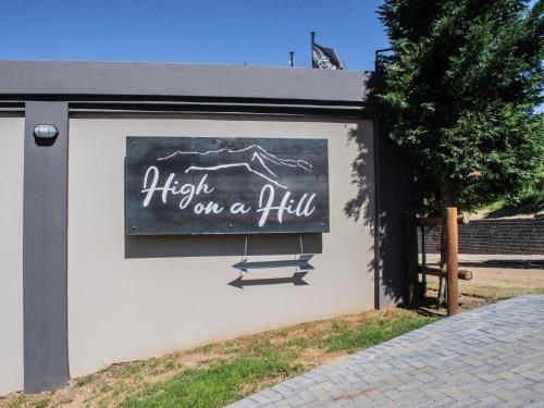 a building with a sign that reads fight on a hill at High on a Hill in Clarens