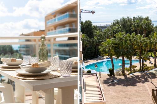 a table with a plate of food on a balcony with a pool at Mediterranean Way - Ontario in Salou