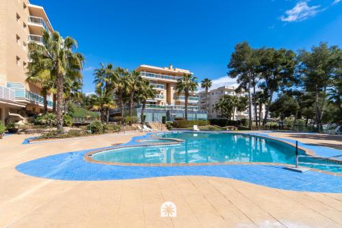 a swimming pool in a resort with palm trees at Mediterranean Way - Ontario in Salou